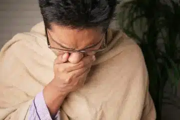 man in brown sweater wearing black framed eyeglasses