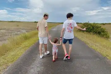 2 boys running on road during daytime